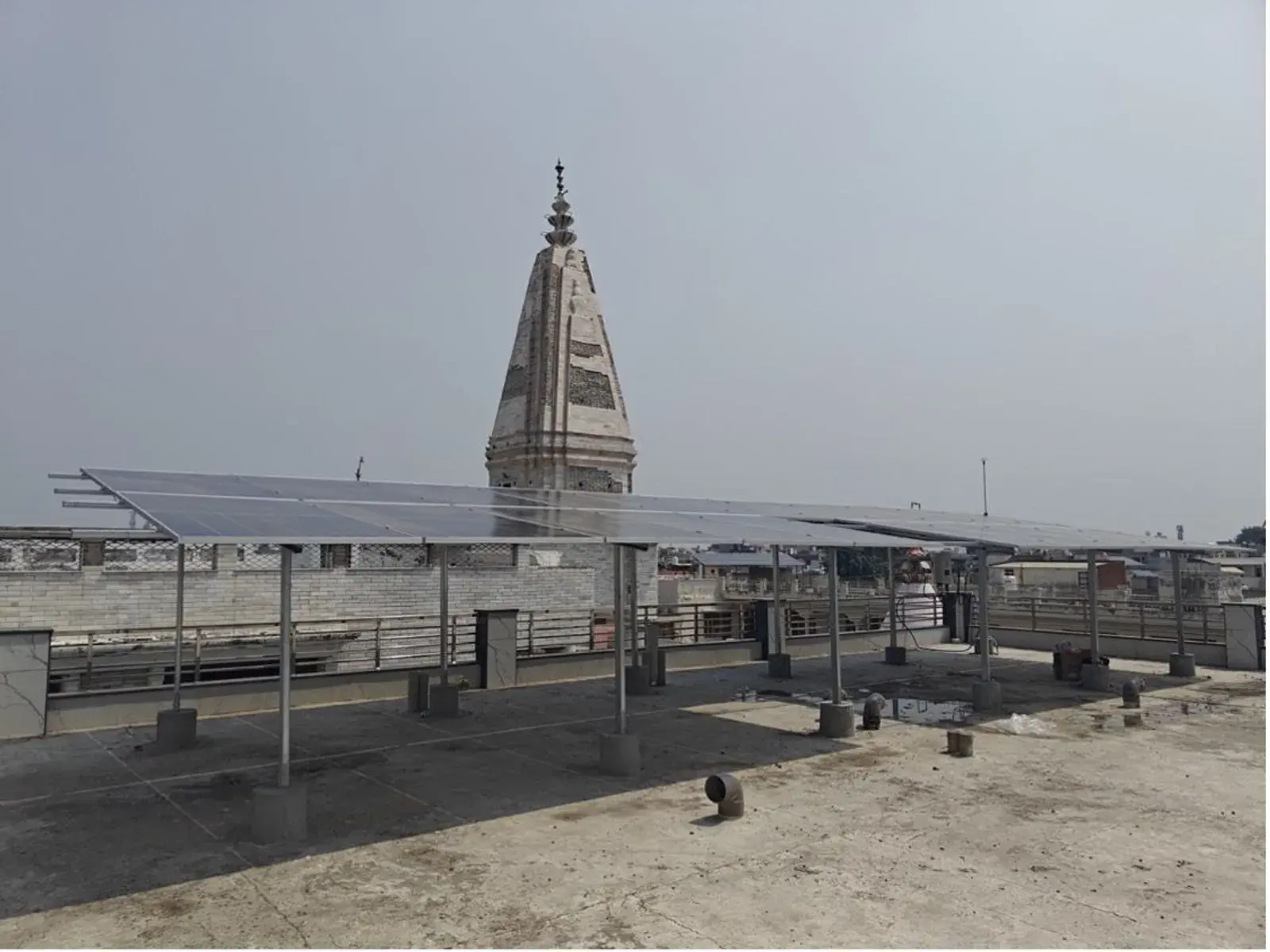 Completed rooftop solar array beside the temple spire