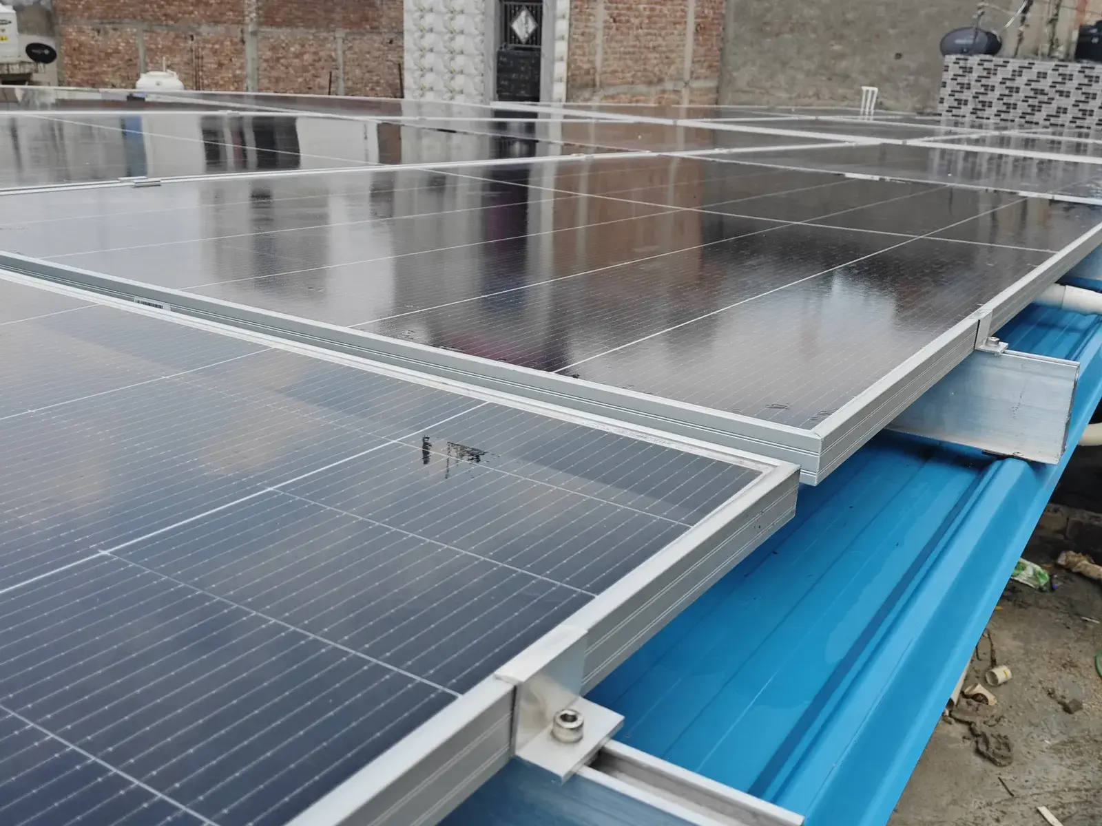 Avaada TOPCon modules clamped to short rails on the tin-shed roof