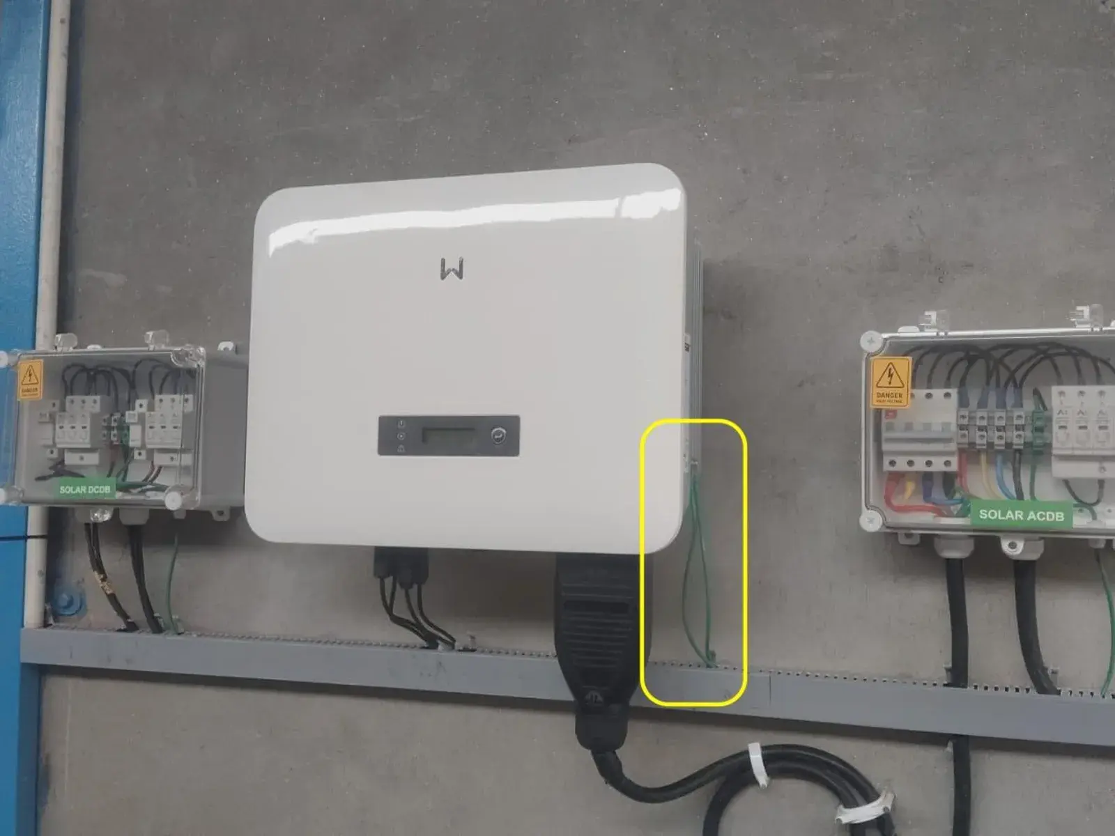 GoodWe inverter on the wall between the DC and AC distribution boxes