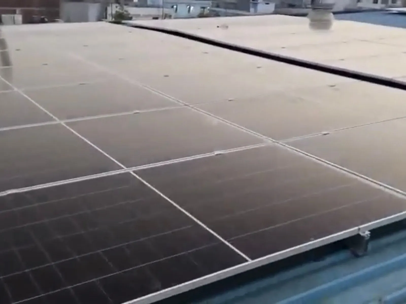 Close-up of Avaada 720 Wp TOPCon modules on the tin-shed roof