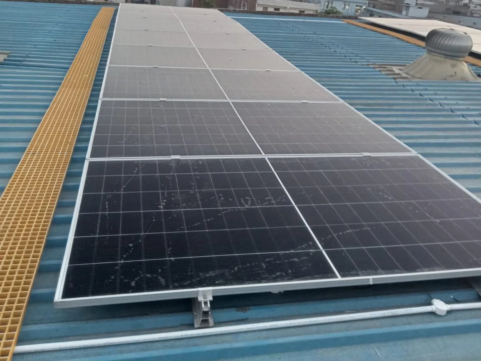 Module row beside a yellow FRP maintenance walkway